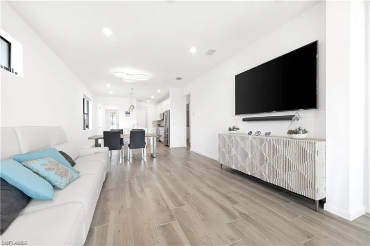 Living room featuring wood tiled floors and recessed lighting