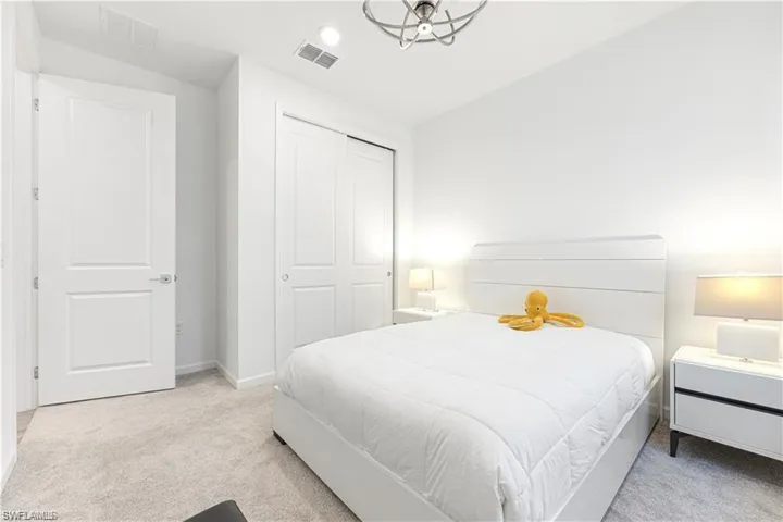 Bedroom featuring light carpet, a closet, and recessed lighting