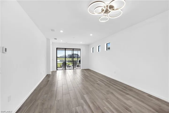 Spare room with wood finish floors and recessed lighting