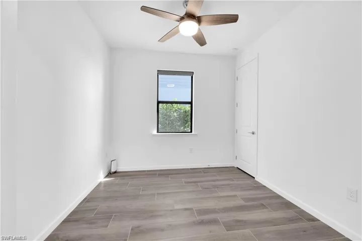 Empty room featuring wood tiled floors and ceiling fan