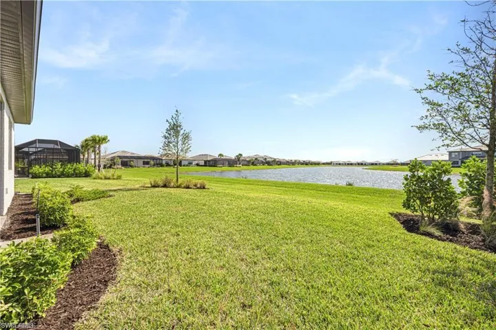 View of grassy yard with a water view and a residential view