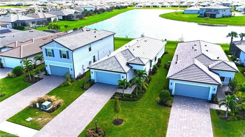 Aerial perspective of suburban area with a nearby body of water