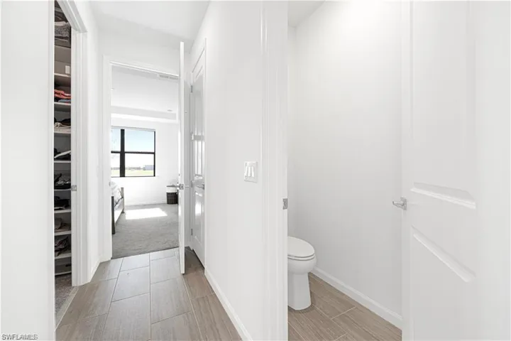 Bathroom with toilet and baseboards