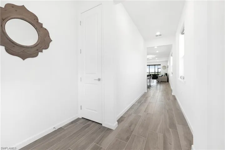 Corridor with wood finish floors and baseboards