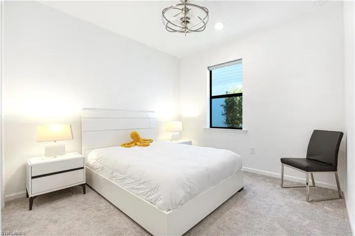 Bedroom featuring light carpet