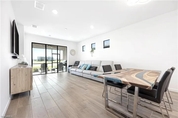 Living room featuring wood tiled floors and recessed lighting