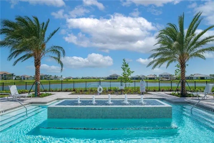 Community pool with a residential view and a patio area