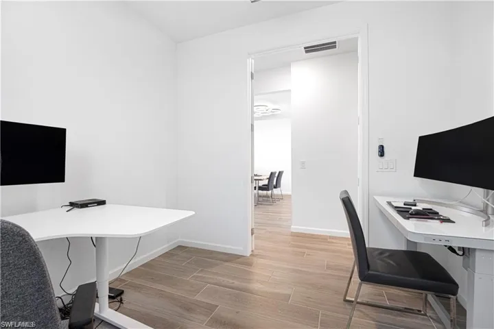 Office space with wood finish floors and baseboards