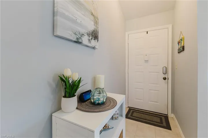 Foyer entrance with light tile patterned floors