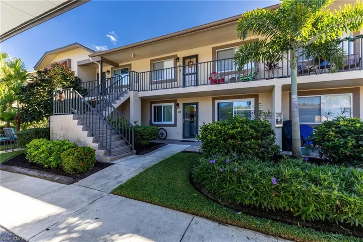 View of property featuring stairs