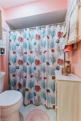 Bathroom with toilet and light tile patterned floors