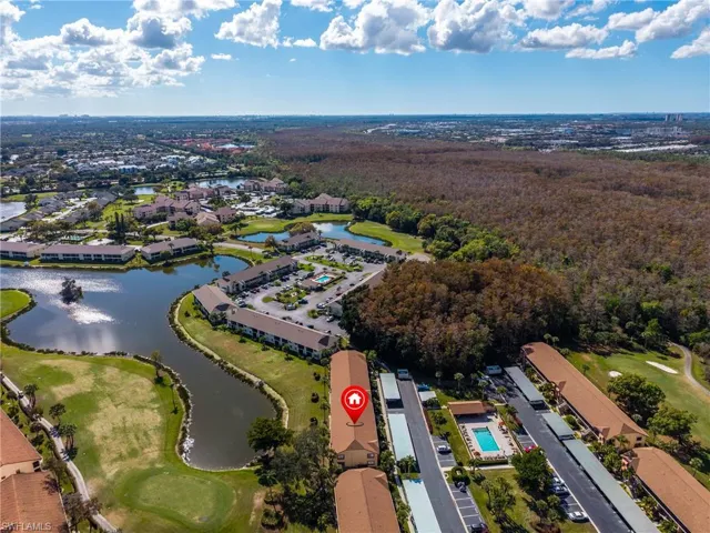 Aerial view of property and surrounding area with a large body of water