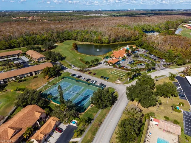 Aerial overview of property's location featuring a nearby body of water and a golf club