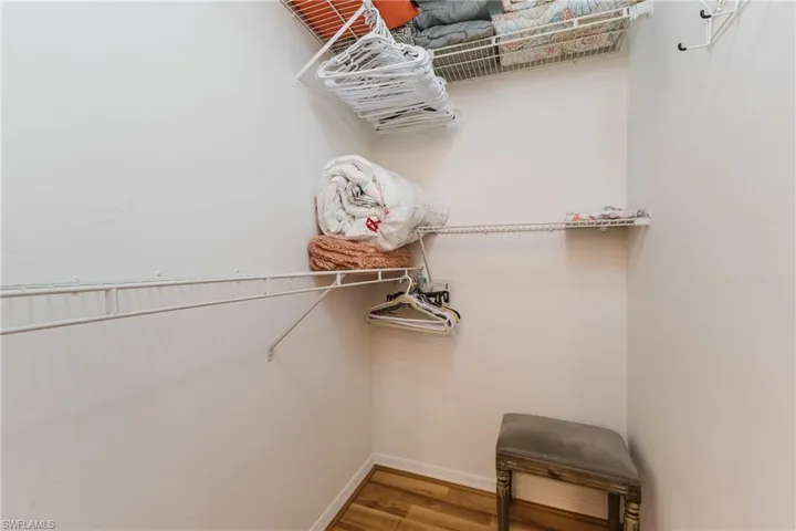 Walk in closet featuring wood finished floors