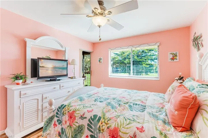 Bedroom with ceiling fan and wood finished floors