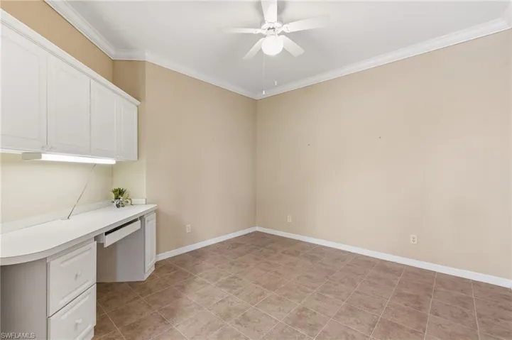 Den - versatile space with built in desk, cabinets. Tile, Crown Molding.