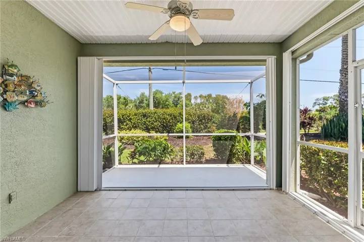 Extended Screened Lanai with tile/concrete flooring. Featuring beautiful big doors with glass inserts and side panels.  Accordian Shutters to protect home.