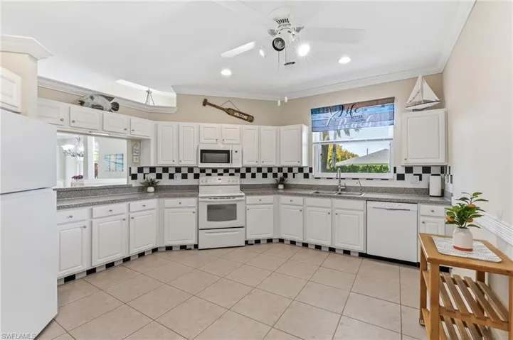 Oversized kitchen with pass-through to dining area, ceramic tile, new refrigerator.