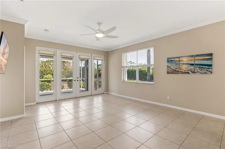 Living Room with ceramic tile, custom window treatments, fan/light fixture.