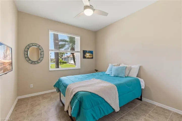 2nd Bedroom with an incredible view of community lake.  Ceramic tile, faux wood blinds, ceiling fan/light fixture.