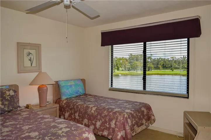 Carpeted bedroom View - featuring ceiling fan