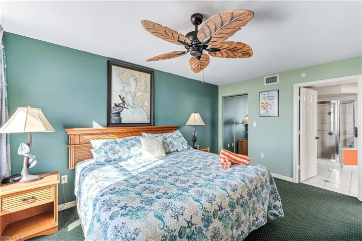 Carpeted bedroom with a closet, ceiling fan, and ensuite bath - VIRTUALLY ENHANCED