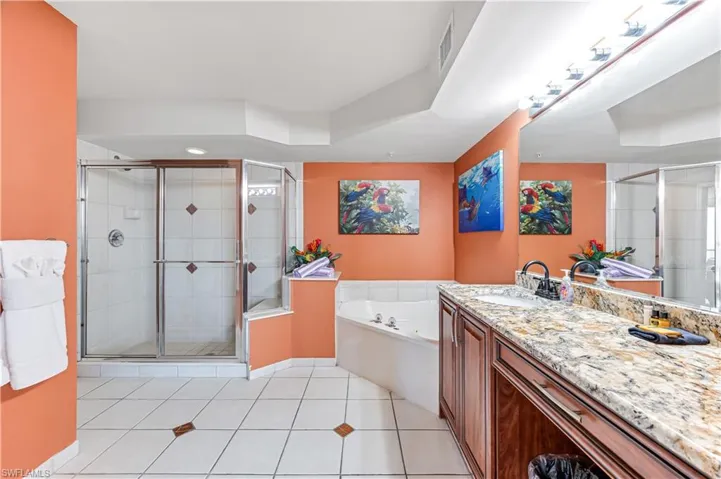 Bathroom featuring vanity, plus walk in shower, and tile patterned flooring - VIRTUALLY ENHANCED