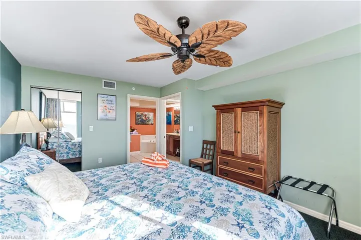 Bedroom with ensuite bathroom, carpet, and ceiling fan - VIRTUALLY ENHANCED