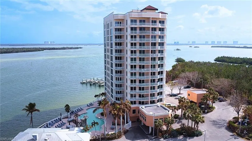 View of property with a water view and a community pool Virtually edited image