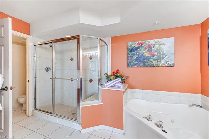 Bathroom with tile patterned flooring, toilet, and separate shower and tub - VIRTUALLY ENHANCED