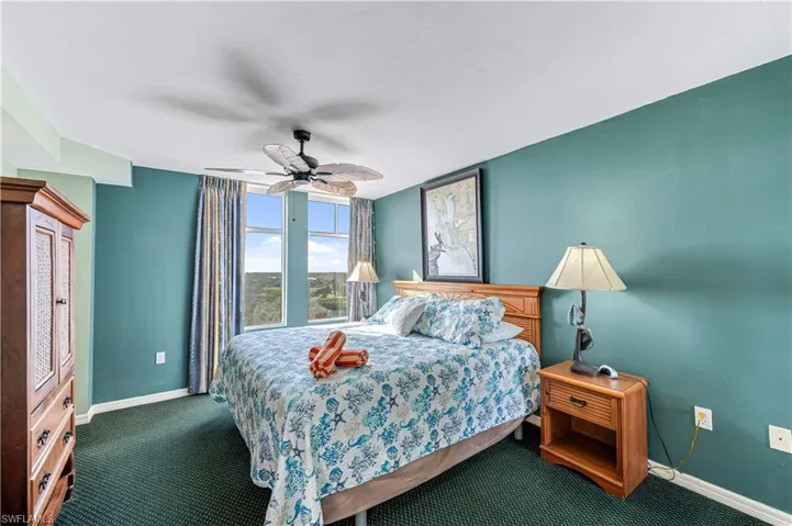 Carpeted bedroom with ceiling fan - VIRTUALLY ENHANCED