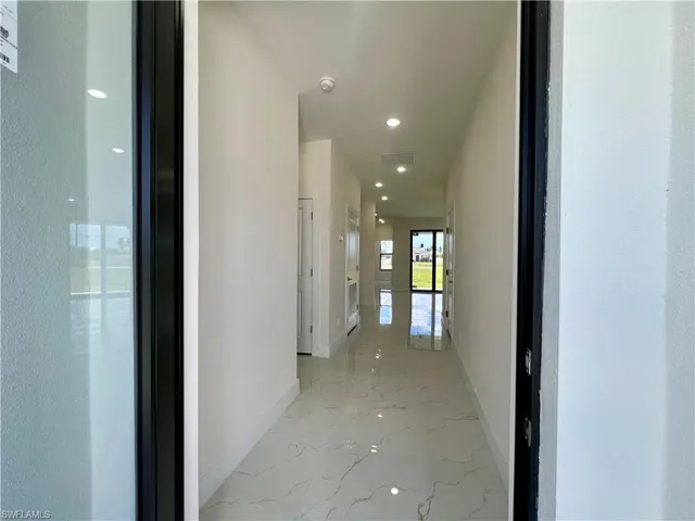 Hallway featuring tile floors