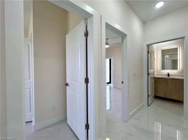 Hall featuring light tile floors
