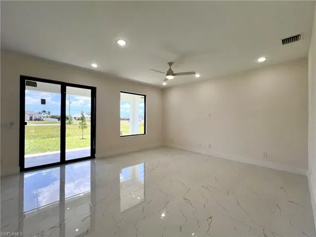Spare room featuring ceiling fan and light tile flooring