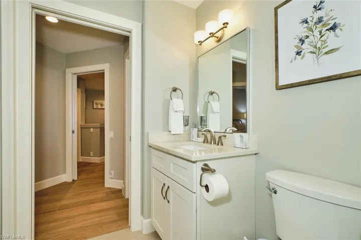 Half bath with vanity and light wood-style floors