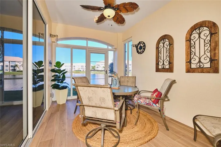 Dining space featuring a water view, wood finished floors, and ceiling fan