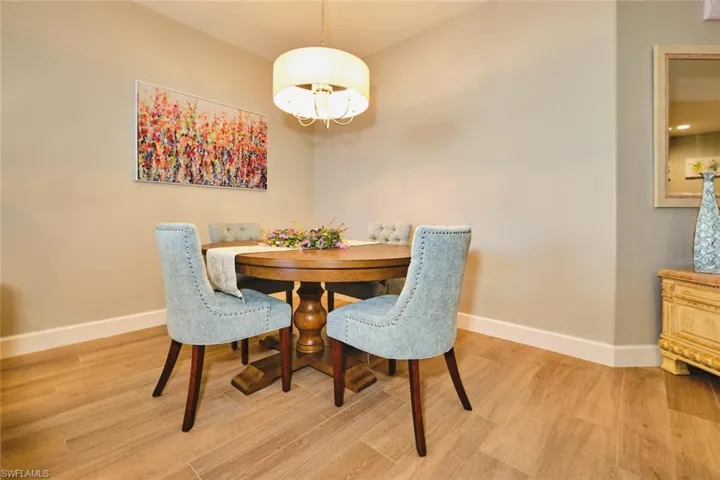 Dining space featuring light wood finished floors and a chandelier
