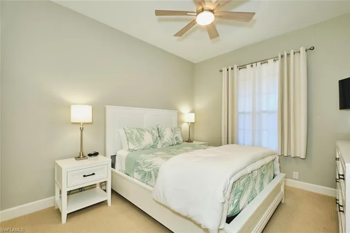 Bedroom featuring light colored carpet and a ceiling fan