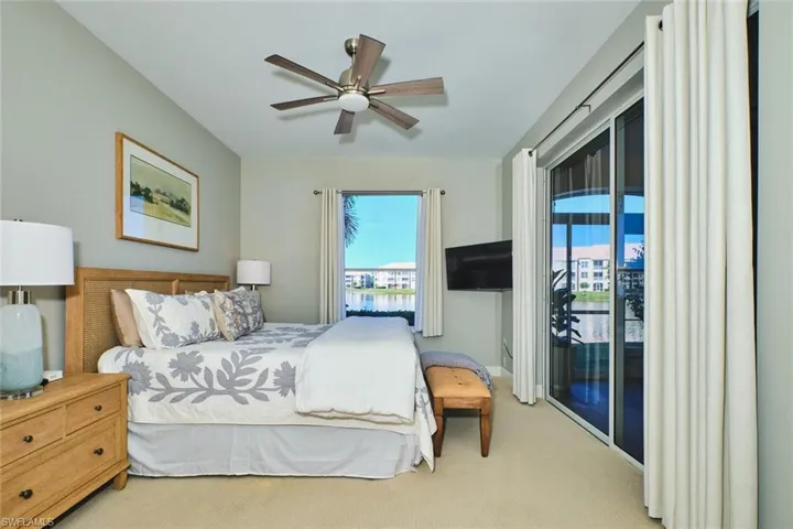 Carpeted bedroom featuring access to outside and a ceiling fan