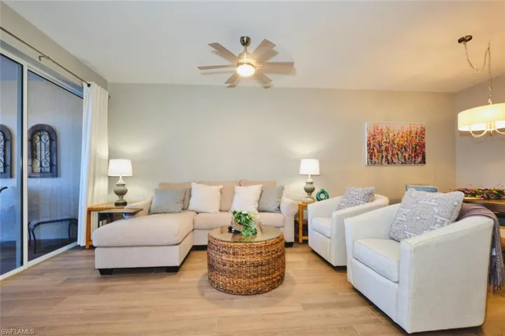 Living area with light wood-type flooring and ceiling fan