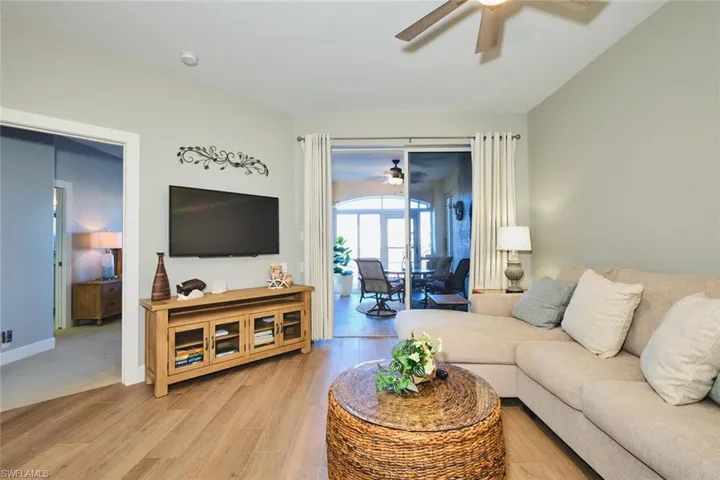 Living room with light wood-style floors and ceiling fan
