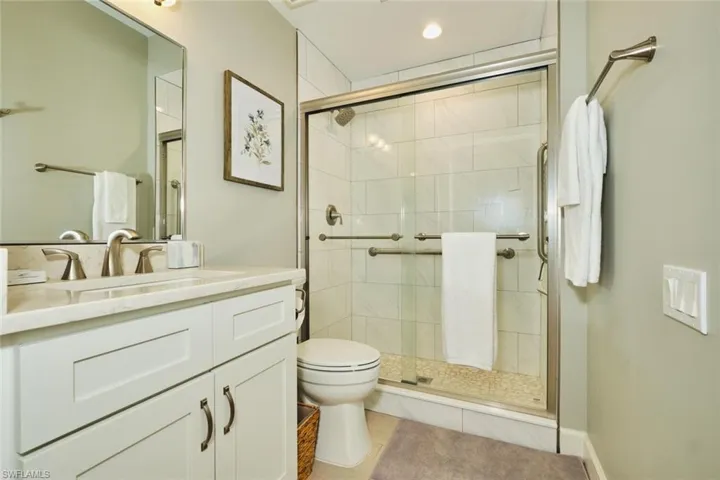 Bathroom with vanity, light tile patterned floors, a shower stall, and recessed lighting