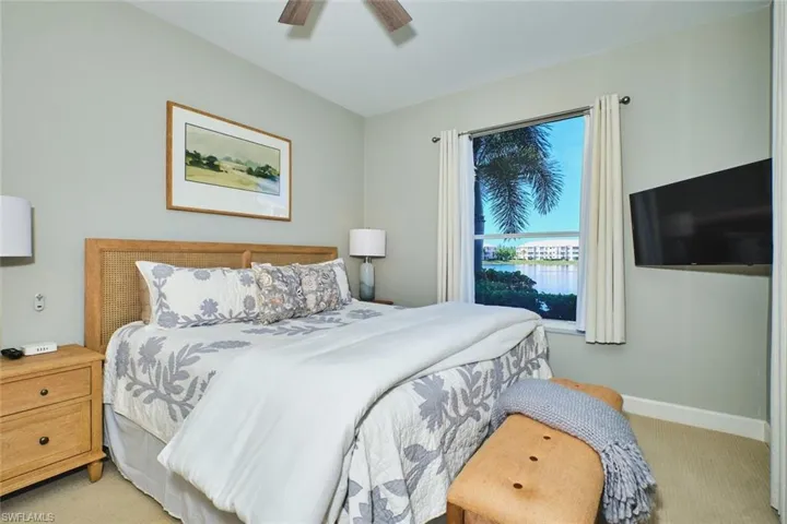 Bedroom with light carpet and a ceiling fan