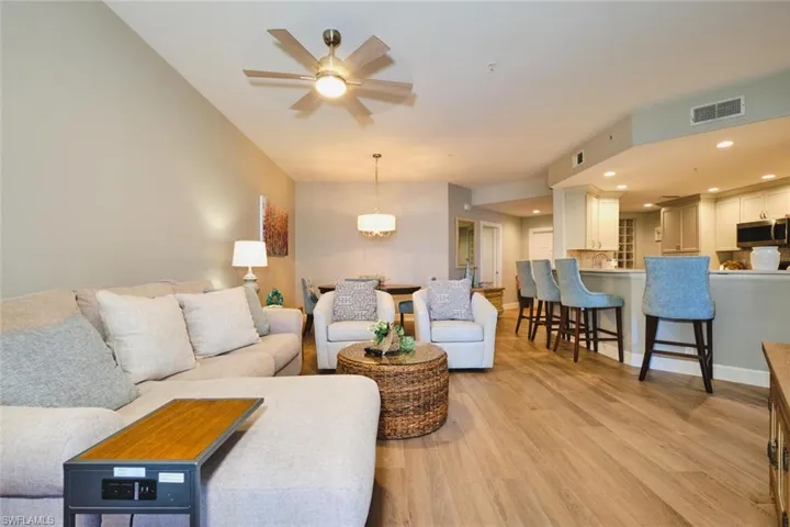 Living room featuring light wood-type flooring, recessed lighting, and a ceiling fan