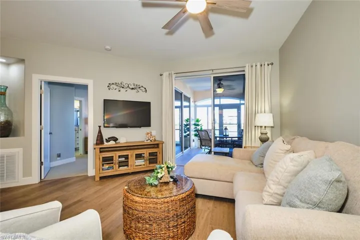 Living room with wood finished floors and a ceiling fan