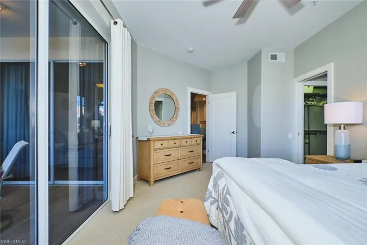 Bedroom with light colored carpet and ceiling fan