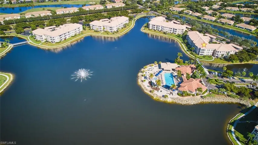 Aerial view of property and surrounding area with a nearby body of water