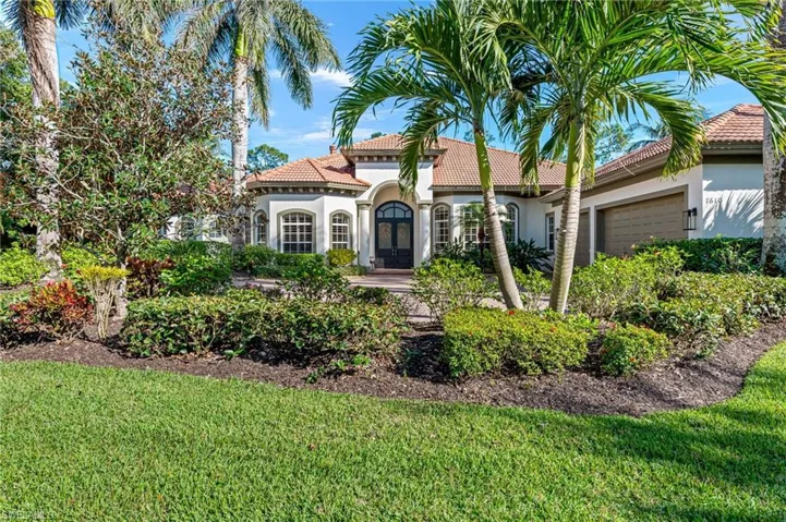 Mediterranean / spanish home featuring stucco siding, a garage, a tile roof, and a front lawn