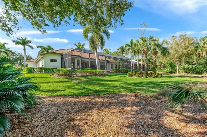 View of green lawn featuring glass enclosure