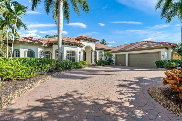 Mediterranean / spanish house with stucco siding, an attached garage, decorative driveway, and a tiled roof